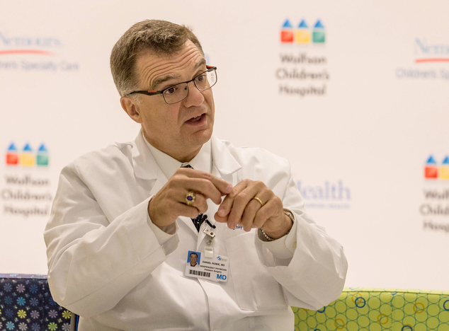 Daniel Robie, MD, team leader of surgery that separated conjoined twin boys Carter and Conner Mirabal, describes the procedure at Wolfson Children's Hospital, Monday, May 11, 2015, in Jacksonville, Fla. The five-month-old Jacksonville boys who shared a liver and small intestine were successfully separated last Thursday, May 7, after a 12-hour operation by three surgeons, five anesthesiologists and 12 other staffers. (AP Photo/Gary McCullough)