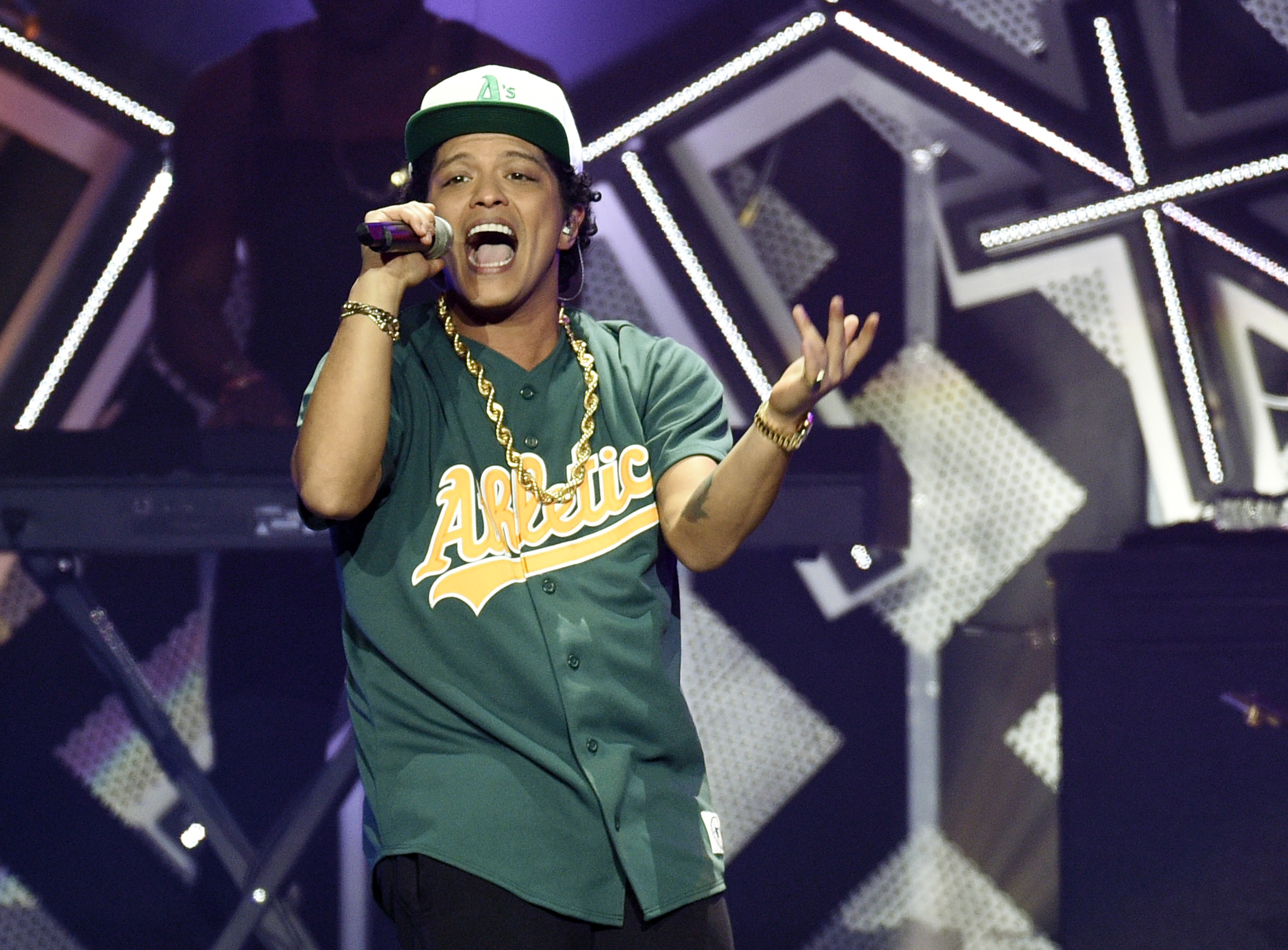 FILE - In this Friday, Dec. 2, 2016, file photo, Bruno Mars performs at the 2016 Jingle Ball at Staples Center in Los Angeles. Drake leads the nominations for the 2017 iHeartRadio Music Awards with 12, including male artist of the year, while electronic duo The Chainsmokers picked up 11 nominations, including song of the year for “Closer.” iHeartMedia and Turner also announced Wednesday, Jan. 4, 2017, that Bruno Mars will perform at the awards show held March 5, 2017, in Los Angeles. (Photo by Chris Pizzello/Invision/AP, File)
